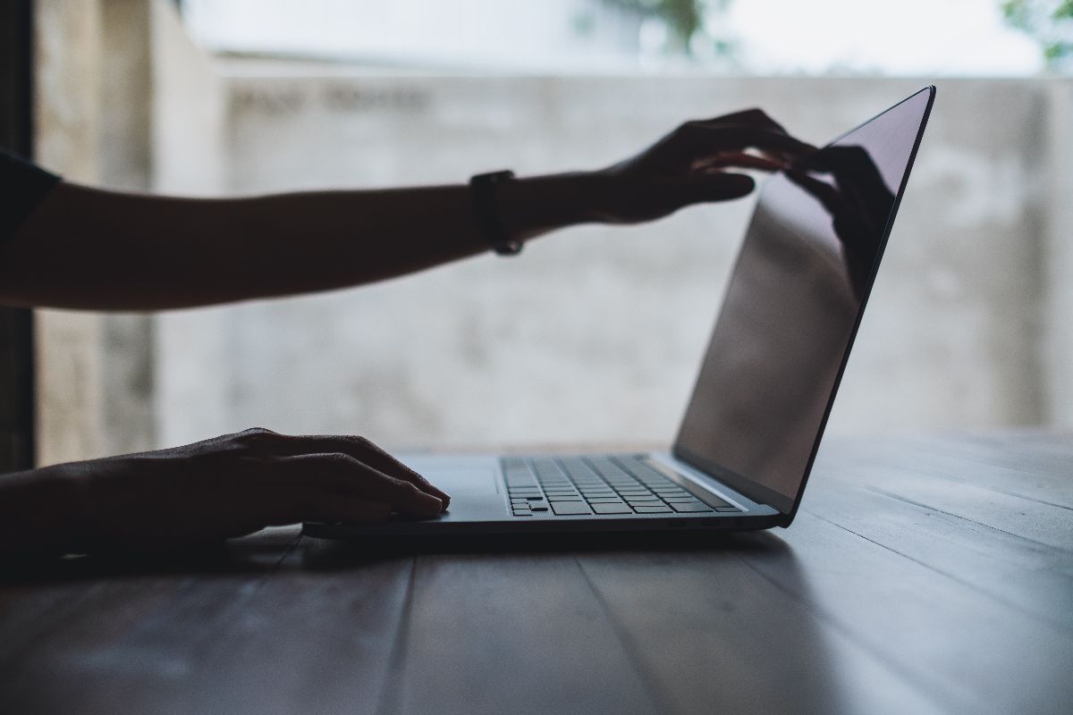 A strategist setting up their laptop to work on their AEO strategy