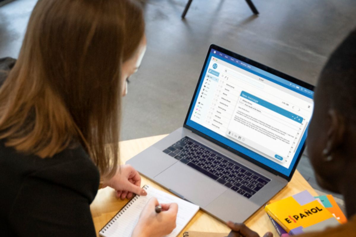 A woman taking notes from an email