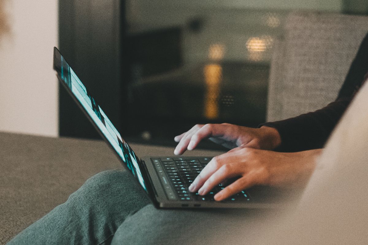 Professional working on a laptop for digital marketing and SEO content strategy tasks.